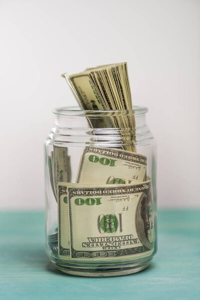 Dollar banknotes in glass jar 