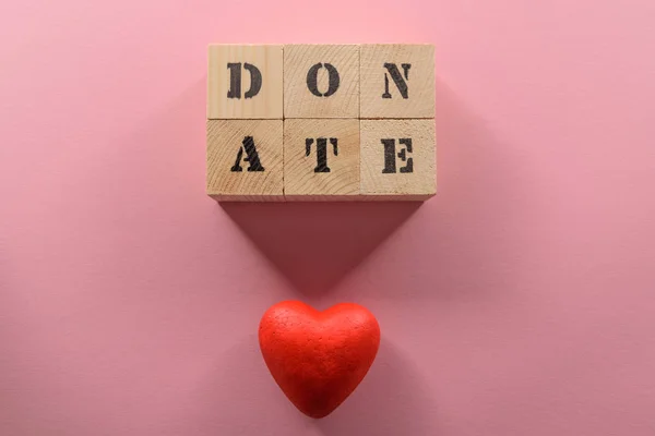 Word donate and heart symbol — Stock Photo, Image