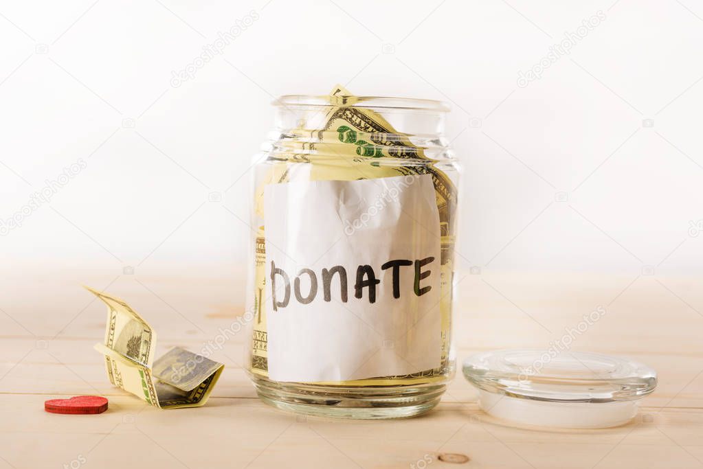 Dollar banknotes in glass jar 