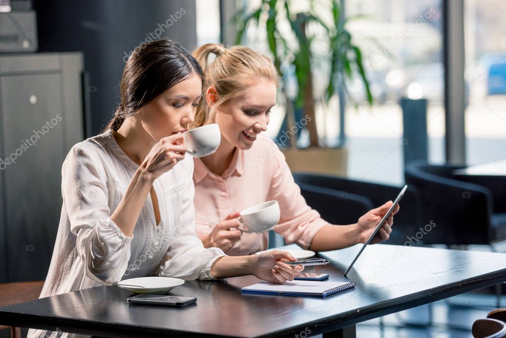 Women using digital tablet 
