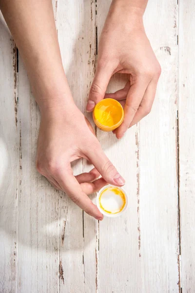 Paint container in hands — Stock Photo