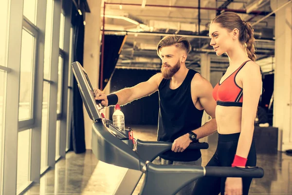 Sportspeople training with treadmill — Stock Photo