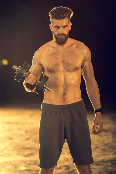 Sportsman training with dumbbell — Stock Photo