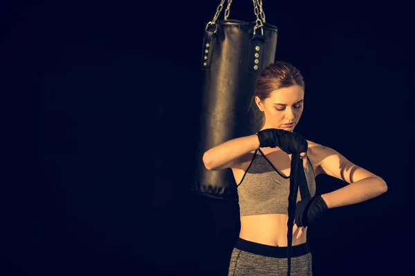 Sportswoman wraping hands — Stock Photo