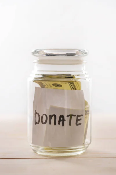 Dollar banknotes in glass jar — Stock Photo