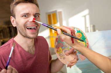 Young couple painting together