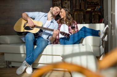 Happy young couple with guitar clipart