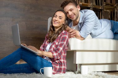 Young couple using laptop clipart