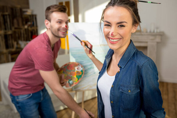 Young couple painting together