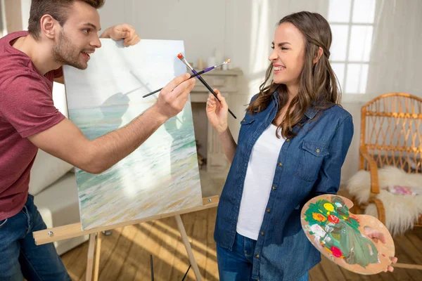 Young couple painting together — Stock Photo, Image