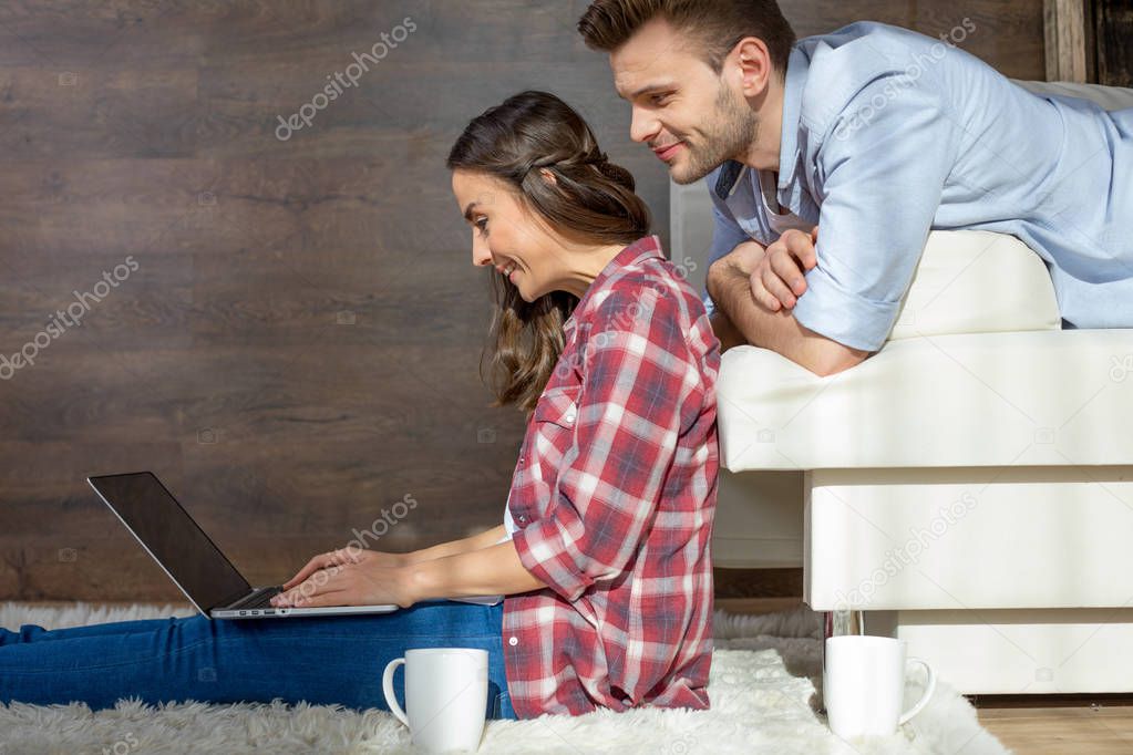 Young couple using laptop