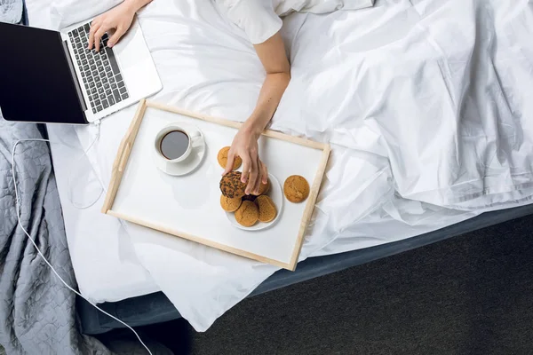 Mujer usando portátil en la cama — Foto de Stock