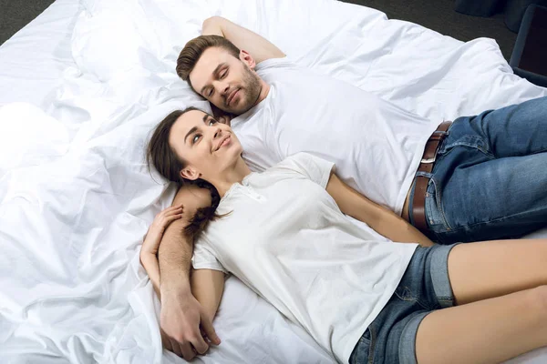 Couple lying in bed — Stock Photo, Image