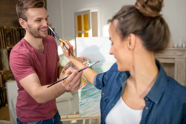 Young couple painting together — Stock Photo