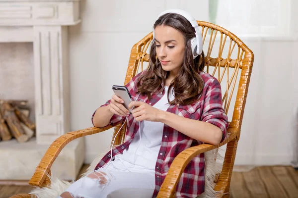 Woman in headphones using smartphone — Stock Photo