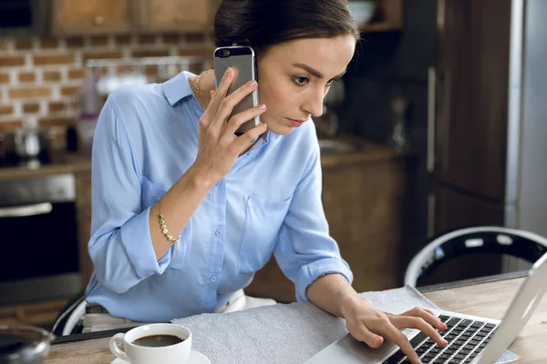 Frau benutzt Laptop und Smartphone — Stockfoto