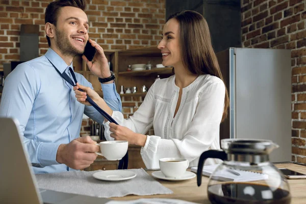 Businesswoman tying tie — Stock Photo