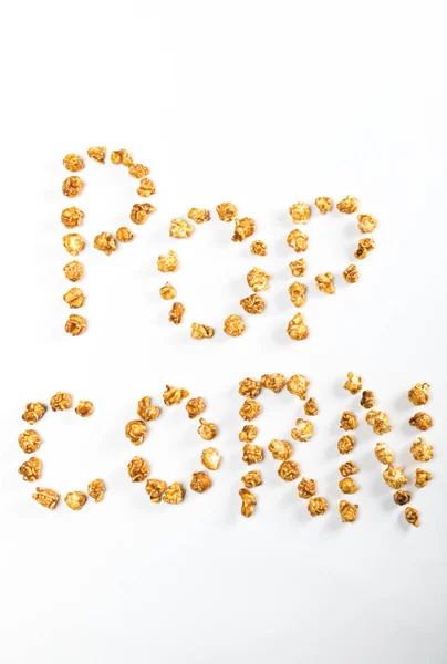 Schriftzug mit Popcornkernen — Stockfoto