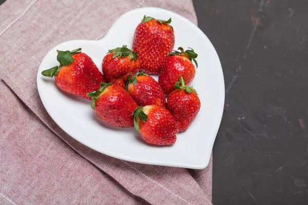 strawberries on heart shaped plate