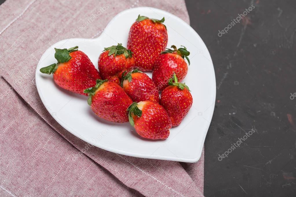 strawberries on heart shaped plate
