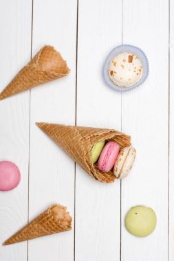 waffle cones with colorful macarons  clipart