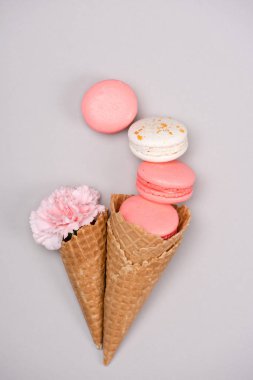 Group of pink macarons with waffle cones clipart