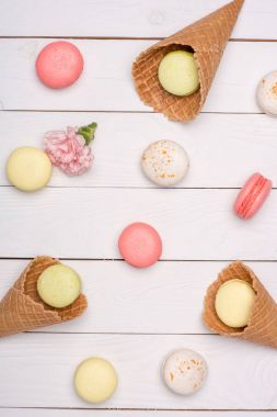 Variety of fresh macaroons in waffle cones clipart