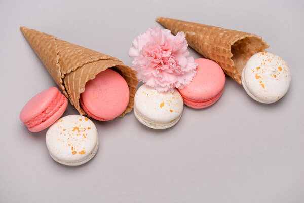 Pink and white macarons in waffle cones