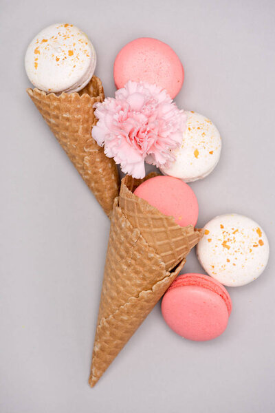 Pink and white macarons in waffle cones