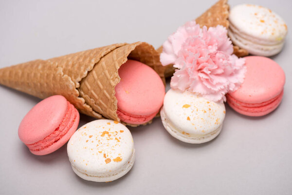 Pink and white macarons in waffle cones