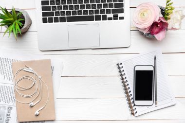 Laptop and smartphone on desk clipart