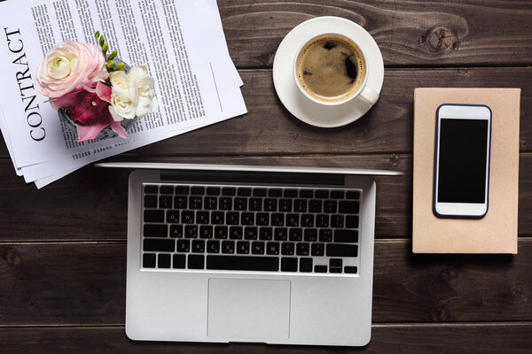 Laptop and cup of coffee on desk