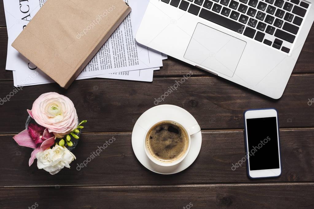 Laptop and cup of coffee on desk