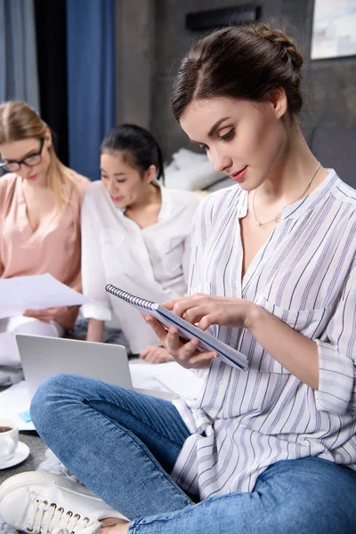 Businesswoman with notebook in hands — Free Stock Photo