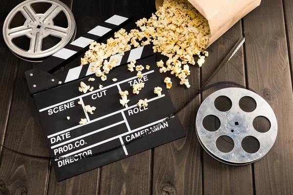 Popcorn and movie clapper board — Stock Photo