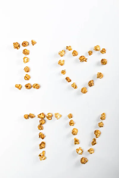 Schriftzug mit Popcornkernen — Stockfoto