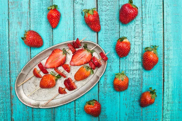 Strawberries on wooden skewers — Stock Photo