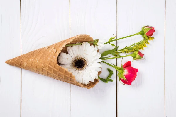 Flowers in waffle cone — Stock Photo