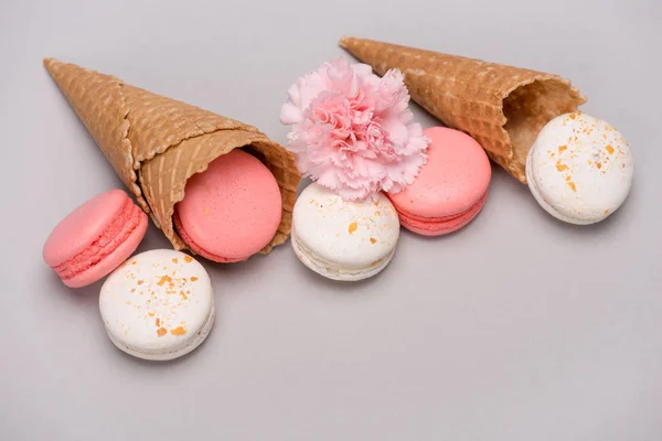 Pink and white macarons in waffle cones — Stock Photo
