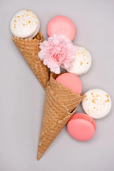 Pink and white macarons in waffle cones — Stock Photo