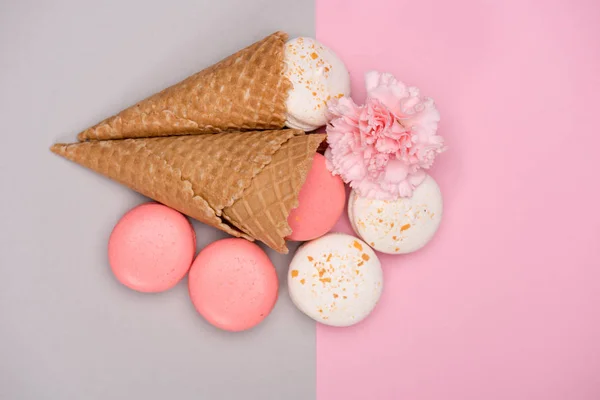 Pink and white macarons in waffle cones — Stock Photo