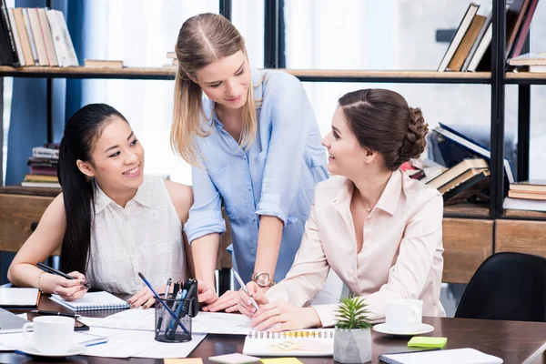 Young businesswomen at workplace — Stock Photo