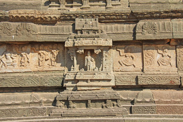 Stone bas-reliefs on the walls in Temples Hampi. Carving stone ancient background. Carved figures made of stone. Unesco World Heritage Site. Karnataka, India. Royal enclosure.