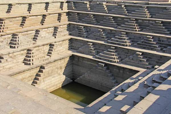 Stepped tank with green water in Pushkarani, Hampi, Karnataka, India. Queens bath. Background geometry. Sacred geometry. Royal enclosure. — Stock Photo, Image