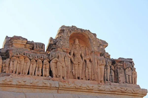 Stone bas-reliefs on the walls in Temples Hampi. Carving stone ancient background. Carved figures made of stone. Unesco World Heritage Site. Karnataka, India. Stone background. — Stock Photo, Image