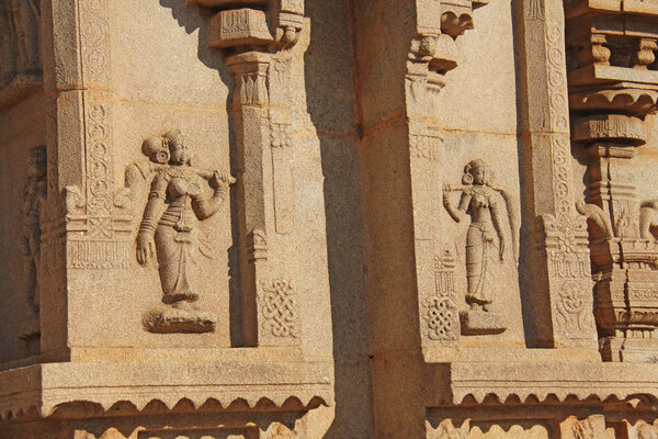 Carving details on the outer wall of Hazara Rama Temple. Hampi, Karnataka, UNESCO. Indian God carving stone.