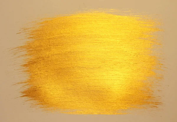 Golden shiny background. Bright golden background, sparkles and shines. A brush stroke.