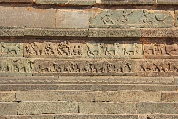 Ανάγλυφα πέτρα στους τοίχους στην Hampi ναούς. Σκάλισμα πέτρα αρχαίας φόντο. Ξυλόγλυπτες φιγούρες από πέτρα. Μνημείο παγκόσμιας κληρονομιάς της UNESCO. Επαρχεία Karnataka της Ινδίας. Βασιλικό περίβλημα. — Φωτογραφία Αρχείου
