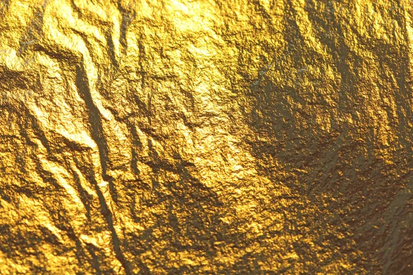 Goldglänzender Hintergrund. leuchtend goldener Hintergrund, funkelt und leuchtet. einen Pinselstrich. Folie. — Stockfoto