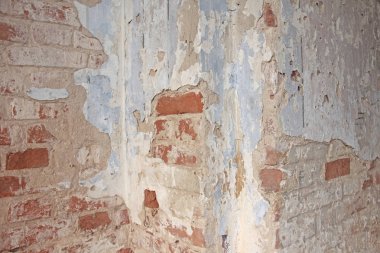Tuğla duvar Pis, beyaz bir duvardan dökülen eski beyaz boya. Çatlaklar, sıyrıklar, eski çimento duvarının arka planında eski boya ve alçı. Eski bir beton duvar çatladı..